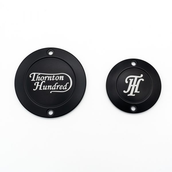 A picture of two engine plaques for a triumph with the Thornton Hundred logos engraved
